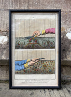 Framed artwork of hands cutting fabric with scissors against a textured stone wall. Antique print of hands trimming a Turkish Carpet 